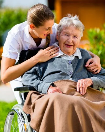 A nurse checking in with a resident in their room